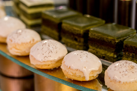 Different sort of beautiful pastry, small colorful sweet cakes