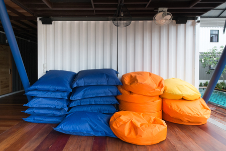 Colorful pile of bean bags with white container wallの写真素材