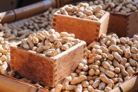 Streamed boiled peanuts in wooden square boxes, being sold in the market