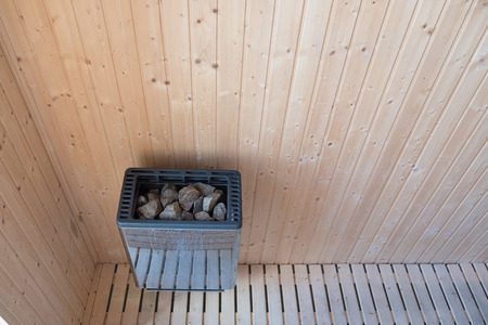 Sauna stone in heater on wooden interior wallの写真素材