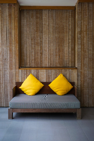 Cozy sofa in room with wooden wallの写真素材