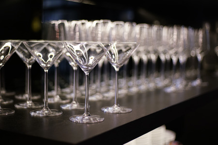 Transparent glasses on black shelf in luxury restaurantの写真素材