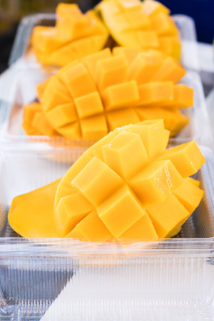 Fresh mango in plastic transparent boxes for take away customersの写真素材