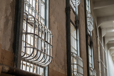 Prison window locked with steel barsの写真素材