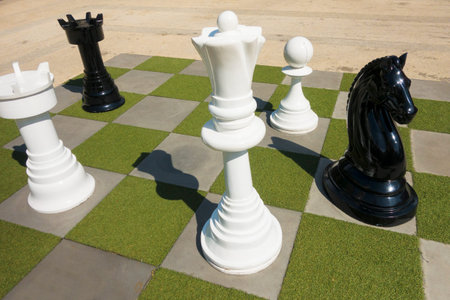 Chess game as decoration in garden with harsh shadow