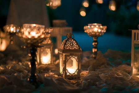 Pale toned candle holders on wrinkled cloths, wedding decorationsの写真素材