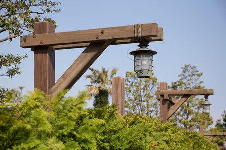 Lamps on street at harbor hanging from wooden poles in sunny dayの写真素材