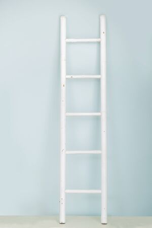 White wooden ladder lean against the wall. Interior decorationの写真素材