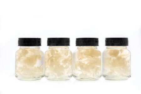 Bird nest packed in glass bottle packaging with black lid. Isolated on white backgroundの写真素材