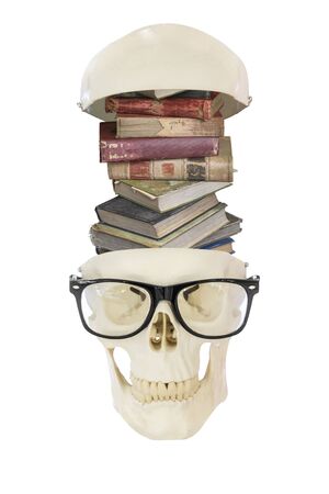 Old worn out pile of books in nerd skull wearing eyeglasses, isolated on white backgroundの写真素材