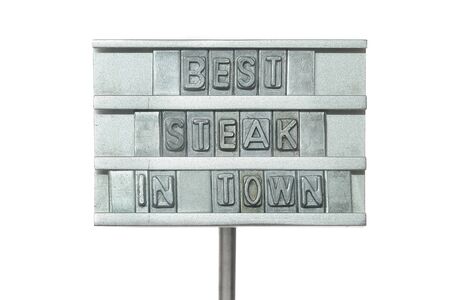 Metal heat stamp says best steak in town, isolated on white backgroundの写真素材