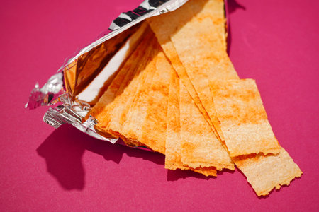 Long rectangular chips on a bright pink background