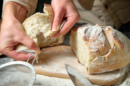 man holding slices of freshly cut bread