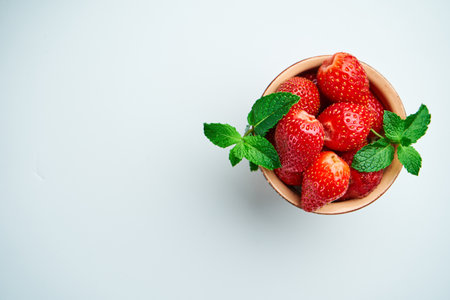 strawberries in a ceramic bowl on topの写真素材
