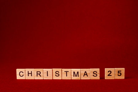 the word Christmas composed of wooden letters on a red backgroundの写真素材