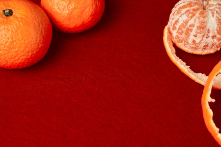 the word Christmas composed of wooden letters on a red background with tangerinesの写真素材