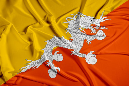 Bhutan official national flag of silk fabric texture. Waving Fabric Flag of Bhutanの写真素材