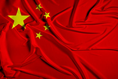 China official national flag of silk fabric texture. Waving Fabric Flag of Chinaの写真素材