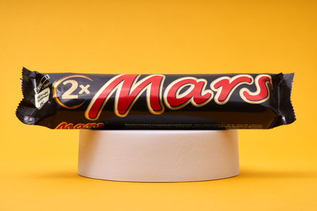 Lviv, Ukraine - February 14, 2024: Mars chocolate bar on yellowのeditorial素材