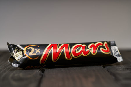 Lviv, Ukraine - February 14, 2024 : Mars chocolate bar on a wooden tableのeditorial素材