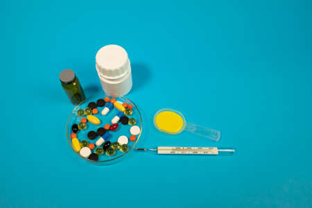 medicine. treatment. covid 19. hospital. hands of a doctor. pills and injections. thermometers and syringes. injections. therapy. human health.の写真素材