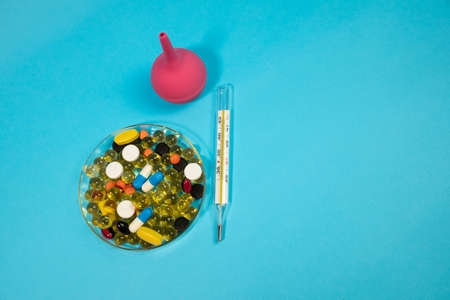 medicine. treatment. covid 19. hospital. hands of a doctor. pills and injections. thermometers and syringes. injections. therapy. human health.の写真素材