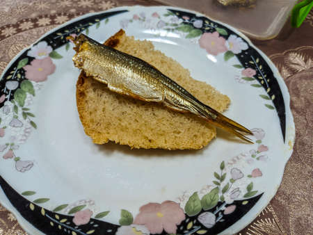 smoked fish. delicious little fish. seafood. sandwich with fish. golden fishの写真素材