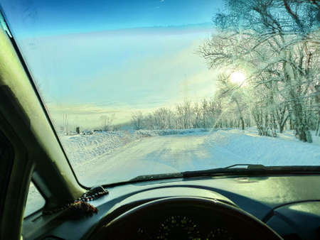 inside the car. driver behind the wheel. drive a car. journey. bad roads. by car. steering wheel and dashboard. wheels and engine.の写真素材