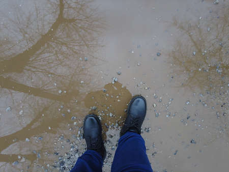 men's footwear. boots. sneakers. feet walk along the road. stroll.の写真素材