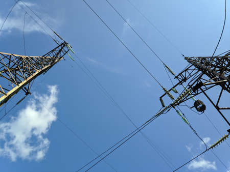 power transmission lines. electrical poles and wires. high-voltage power lines at sunset, high voltage electric transmission tower. High Voltage towers provide power supply over a long distance.の写真素材