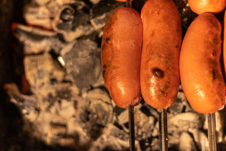 fried sausage and sausages. Grilled sausages with sauce ketchup on a wooden table.の写真素材