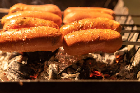 fried sausage and sausages. Grilled sausages with sauce ketchup on a wooden table.