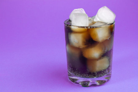 cola and ice in a glass. carbonated drink. Glasses of sweet carbonated drinks with ice cubes isolated on white. With clipping path. Background of cola with ice and bubbles.の写真素材