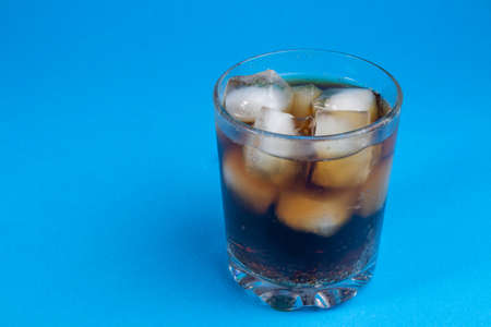 cola and ice in a glass. carbonated drink. Glasses of sweet carbonated drinks with ice cubes isolated on white. With clipping path. Background of cola with ice and bubbles.の写真素材