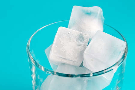 white ice cubes in a transparent glass. ice melts in a glass. transparent ice.の写真素材