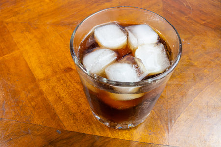 white ice cubes in a transparent glass. ice melts in a glass. transparent ice.