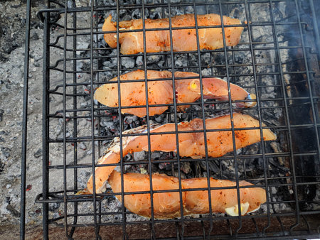 cooking fish on fire. grilled fish. Grilled mackerel fish with smoke on a charcoal barbecue grill....