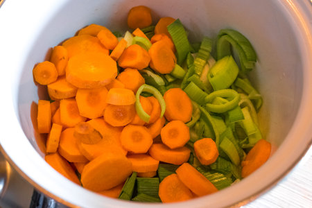 making homemade soup. delicious homemade soup. Ladle with vegetable soup. Cooking pot on background. Focus on foreground. Bowl of tasty chicken enchilada soupの写真素材