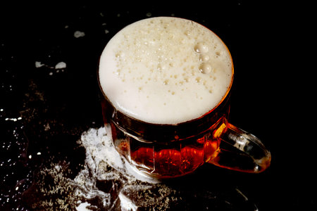 mug of beer on a dark background. beer glass. beer and fish. foam in a glass. gas bubbles. Glass of light beer. Beer glasses on a dark table. Stock Photo mug of cold foamy beer close-up.の写真素材