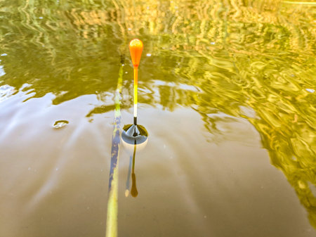 fishing on the river. fisherman with a fishing rod. catch . Fishing rod wheel closeup, man fishing...