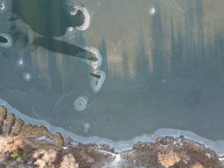 landscape with water from above. Aerial view of sandy beach and ocean with waves. Photo taken by a...