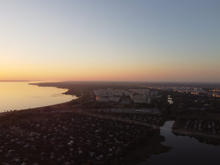 landscape with water from above. Aerial view of sandy beach and ocean with waves. Photo taken by a drone from above. natural landscape. Aerial view of a green grassy forest.の写真素材