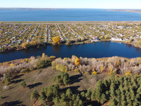 landscape with water from above. Aerial view of sandy beach and ocean with waves. Photo taken by a drone from above. natural landscape. Aerial view of a green grassy forest.の写真素材