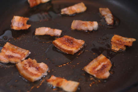 fried bacon. lard in a frying pan. Fried the bacon in a frying pan. Fried Bacon. Lard with a layer. Fried lard in a pan.の写真素材