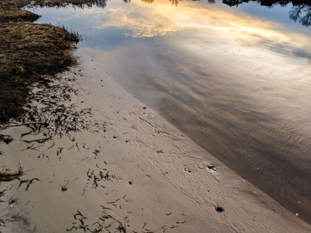 glare and reflections on the water. the sky is reflected in the water. Background of waves,...