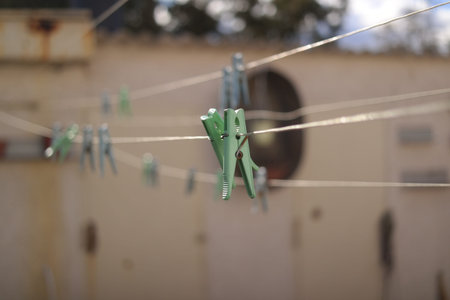 old pegs on a rope. One old retro clothespin wooden on a linen rope. Work on the house, washing,...