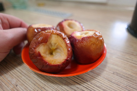 baked apples. Baked apples stuffed with cheese cake and caramel. Baked apple isolated on a white background.の写真素材