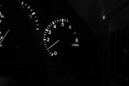 analog automotive devices. cars from the nineties. arrows on the dashboard. speedometer. tachometer. black and white.の写真素材