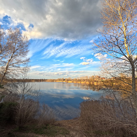 landscape on the river. reflection of the sky in the water. on the shore. rivers. natural landscape with water. sunny evening on the lake. Ukrainian landscape. Dnepr River. Calm water at sunset.の写真素材