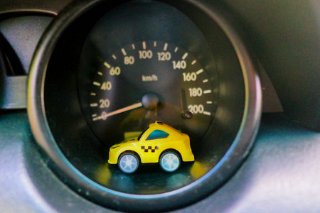 toy car in a big car. small taxi car. yellow taxi. public transport. concept toy taxi car.の写真素材